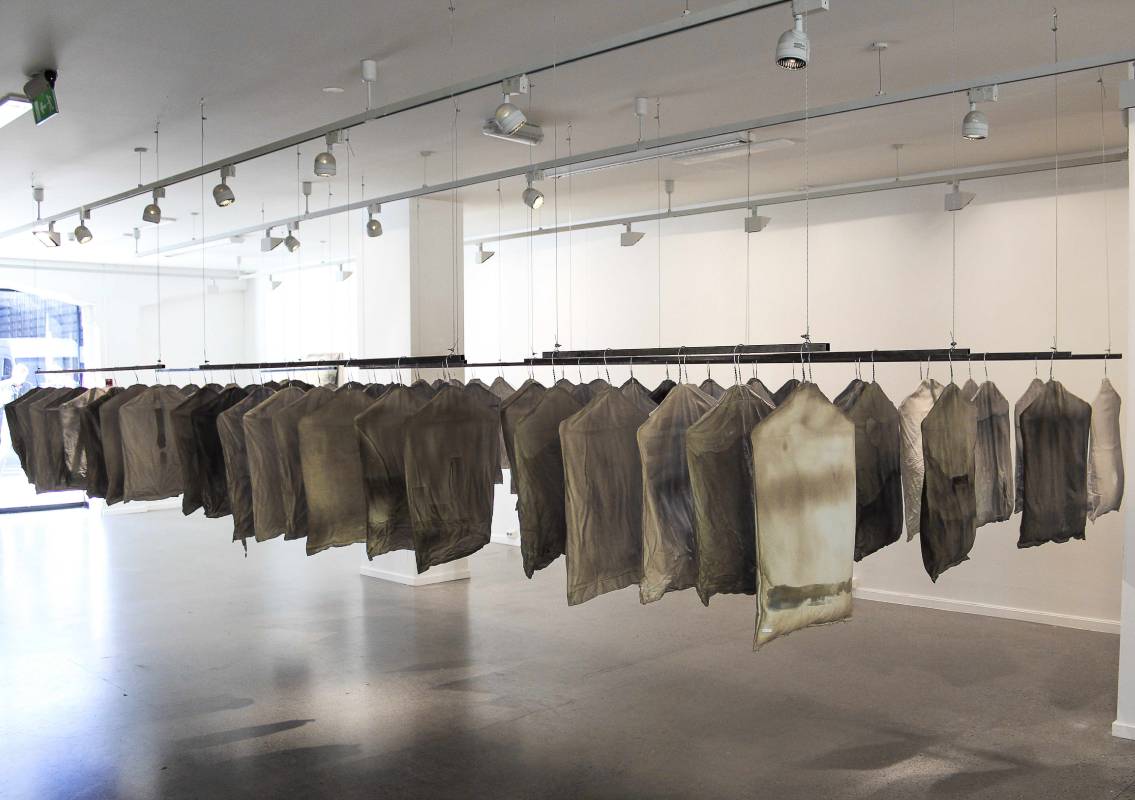 Garment bags, 2016, Dimension variable, 80 small torso-like Textile objects stuffed, stained by coffee...