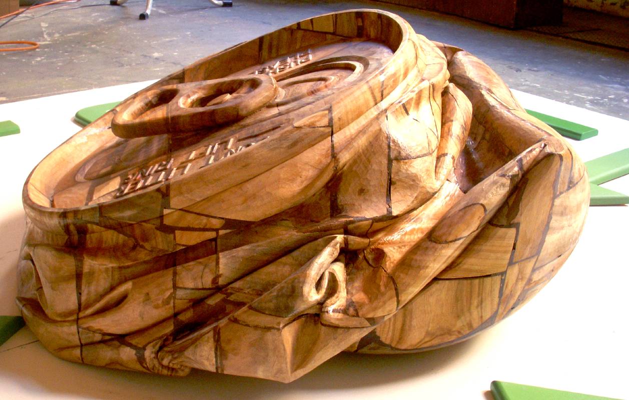 藝術家：林志航　　標題：壓扁了「再」來　     尺寸：Ｈ：40 * 92 * 86 cm  　材質：木雕／樟木　　年代：2010